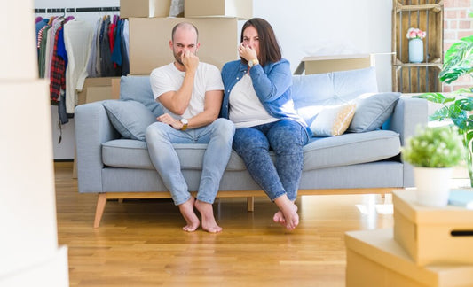 couple on a couch covering their noses with their handsP-trap under a kitchen sinkrotten eggs with mildew growth in refrigerator